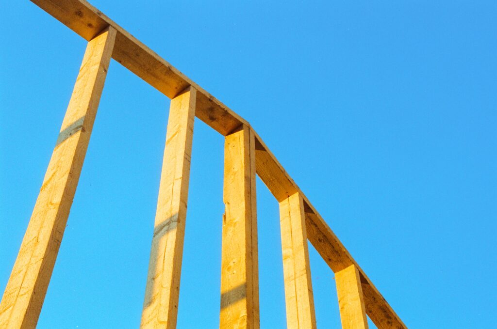 wood frame of building on clear blue day
